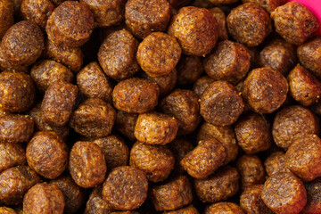Dry pet food granules for background top view