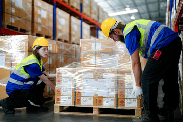 workers using Laser Barcode Scanner to checking stock items for shipping. male and female...