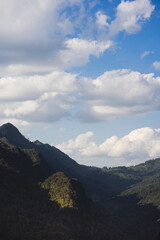 travel in nature concept with tropical forest on mountain and clear sky in springtime season