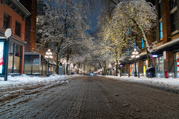 Vancouver, British Columbia - Canada. Downtown iconic landmark on a snowy night just after a snowstorm, the Steam Clock, Gastown- Vancouver, British Columbia, Canada.