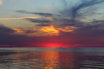 Colorful sunset on the shore of Lake Chudskogo. Pskov region, Russia.