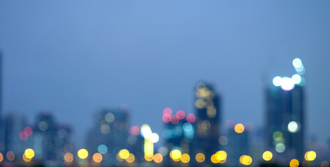 Abstract blurred background cityscape of Krung Thep Maha Nakhon (Bangkok) on night scene with multicolour bokeh from neon light on building