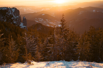Fototapeta na wymiar Beautiful sunrise at winter in Ceahlau Mountains, Romania
