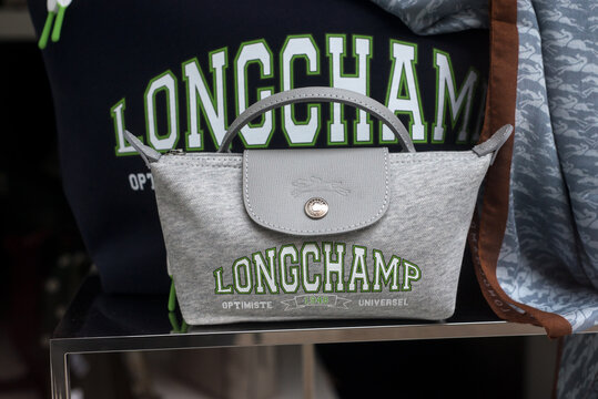 Mulhouse - France - 11 february 2024 - Closeup of grey summer longchamp hand bag in a luxury fashion store