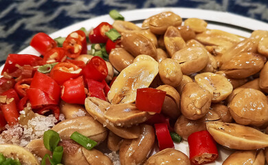 Zoom in selective roasted peanuts with salt and fresh chili