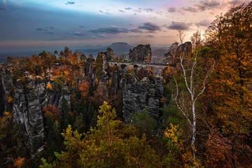 Peel and stick wall murals Bastei Bridge Saxon, Germany - The Bastei bridge with a sunny autumn sunrise with colorful foliage and sky. Bastei is famous for the beautiful rock formation in Saxon, Saxon Switzerland National Park