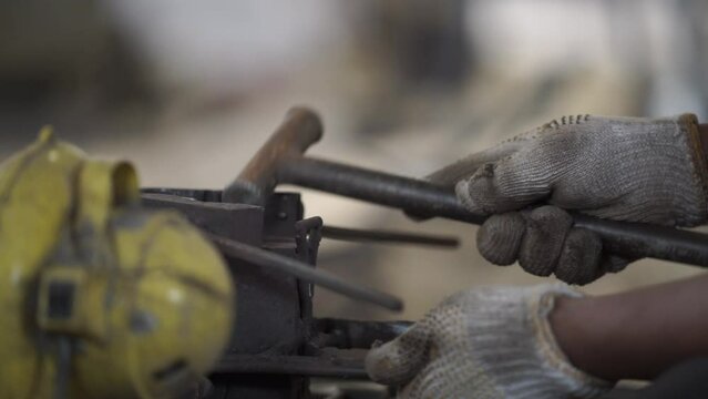 close up of a hand holding a metal mold