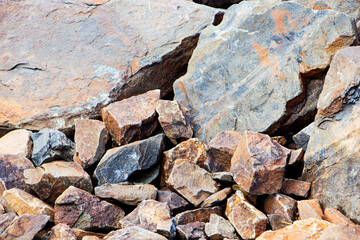 Rockfall on the road in the mountains. Stones of different sizes. Landslides.