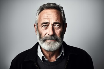 Portrait of a handsome senior man with grey beard and mustache.