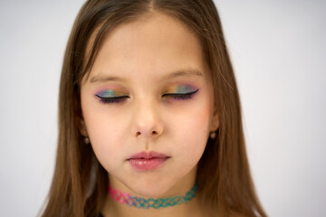 Naklejka premium Close-up portrait of a cute girl with beautiful makeup, face