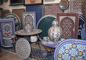 Tabletops, wall panels, fountains with a traditional Moroccan pattern of multi-colored mosaics. Traditional moroccan souvenirs, souk in Essaouira, Morocco, North Africa