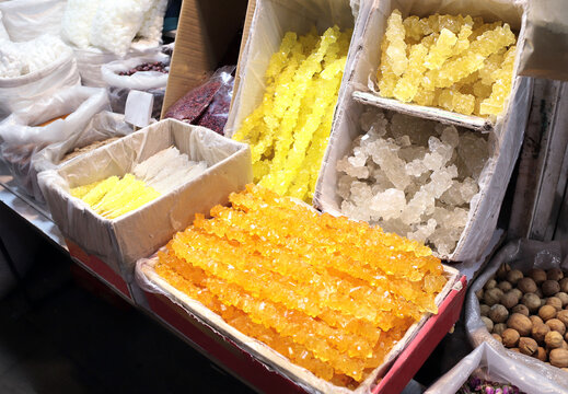 Persian Saffron Rock Candy Nabat on street market. Crystallized sugar with saffron - traditional iranian dessert. Saffron Rock Candy Sugar Crystal sale, Iran