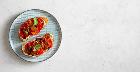 Sweet ripe cherry tomatoes with balsamic sauce on toast bread. Copy space, top view.