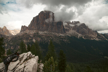 Traveller bagpack in breathtaking landscape of Dolomites Mounatains. Travel lifestyle wanderlust adventure concept.