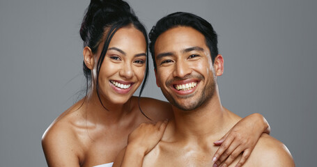 Couple, smile and care for skincare, happy and portrait for wellness in studio by gray background....