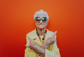 Funny grandmother portraits. Senior old woman dressing elegant for a special event. Rockstar granny on colored backgrounds - 733637593