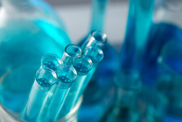 Chemical test tubes close-up with blue liquid. Medicine, pharmaceuticals, chemistry