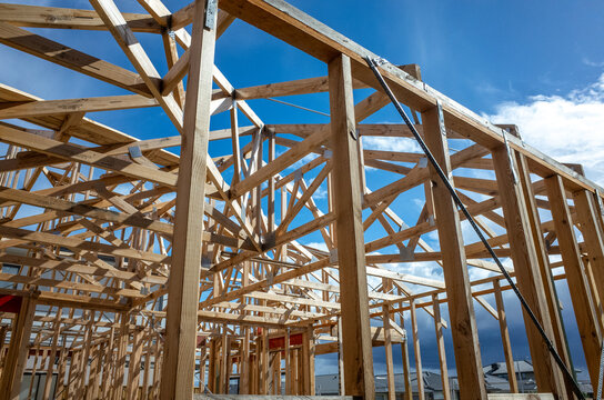 Wooden structure or timber frame of a residential suburban home at a construction site. Concept of self build home, housing market in Australia, house and land package and unfinished carpentry work.