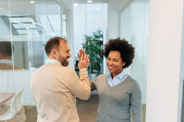 Employees doing the high five in the office