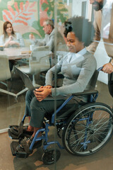 Fototapeta na wymiar Office worker in a wheelchair working in a conference room