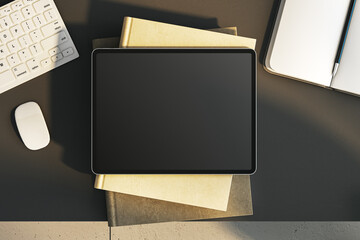 Top view of empty tablet on black office desk with supplies and equipment. Mock up, 3D Rendering.