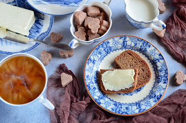 Coffee with milk and bread with butter