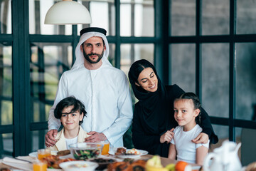 Traditional arabian family from Dubai spending time together at home - 733665750