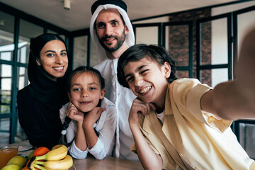 Traditional arabian family from Dubai spending time together at home - 733665788