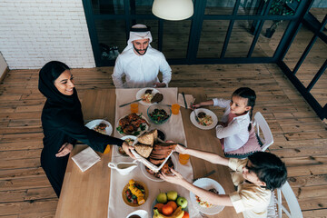 Traditional arabian family from Dubai spending time together at home - 733665795