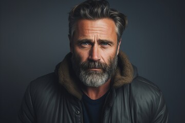Portrait of a handsome mature man with long gray beard and moustache in a black jacket. Men's beauty, fashion.