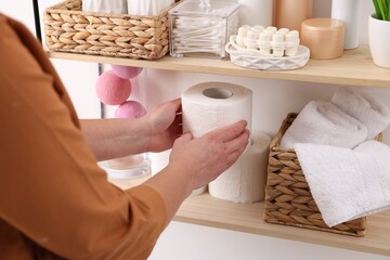 Bath accessories. Woman organizing personal care products indoors, closeup