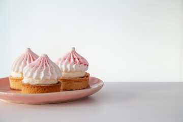 cupcake on pink plate  on white table