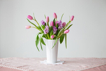 spring flowers in white vase in vintage style