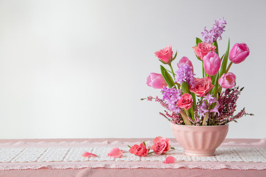 pink flowers in vase on background white wall