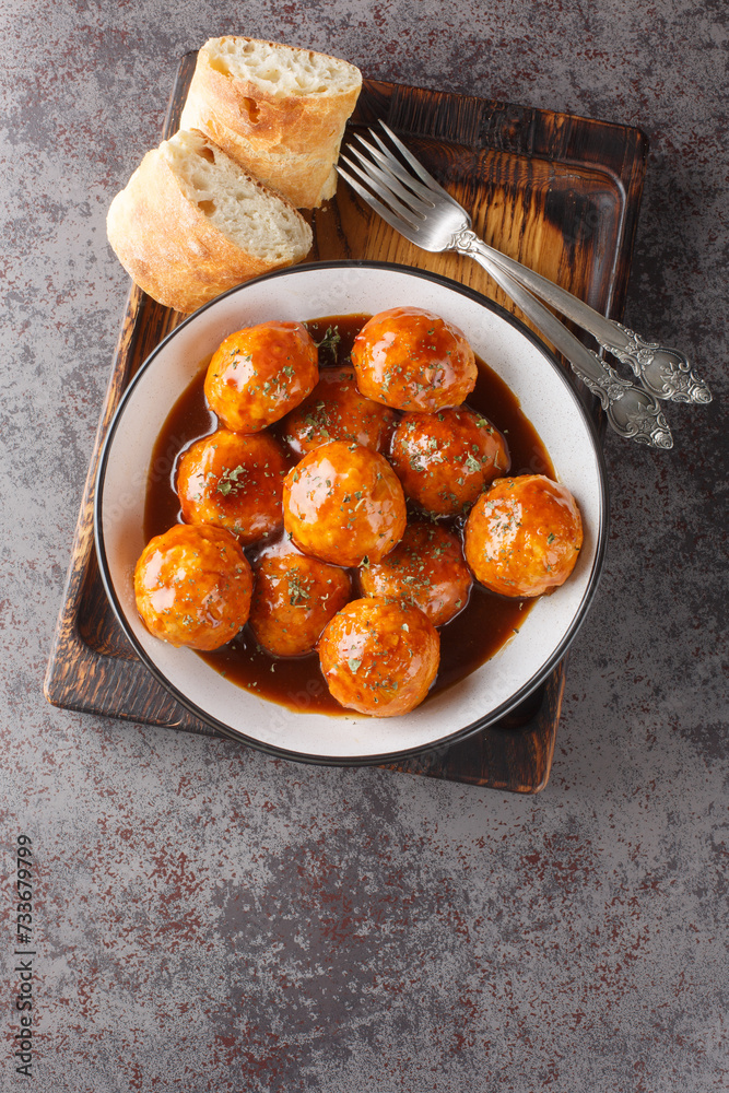 Wall mural chicken meatballs in honey glaze and spicy sauce close-up in a bowl on the table. vertical top view 