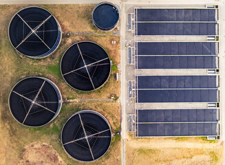 Wastewater treatment plant aerial top view of massive water tanks for water filtration and...