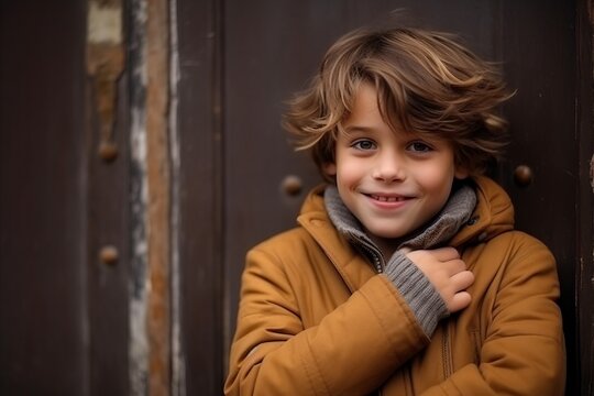 Portrait of cute little boy in coat and scarf, outdoor shot
