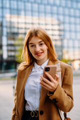 Portrait woman executive posing at downtown with her phone