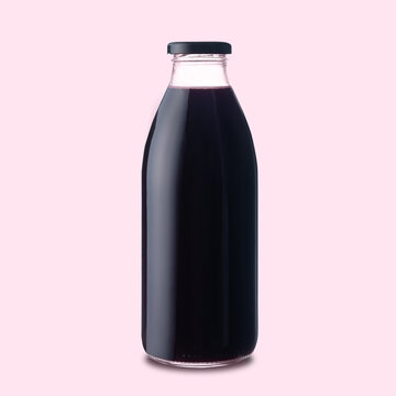 Berry fruit juice of dark red color in a glass bottle on an isolated pink background.