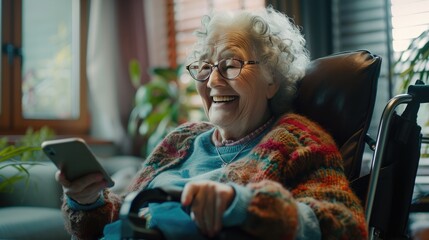 Portrait of smiling senior woman on wheelchair with smartphone at living home.