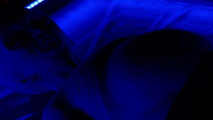 Area 51. A life-size humanoid after a UFO crash. An alien in ultraviolet light. Whole-body view