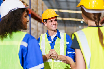 team of warehouse personnel is conducting a comprehensive stock inventory using laptop computers within the confines of the warehouse.