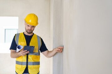 foreman checking the under construction building. Caucasian male engineer inspects interior.