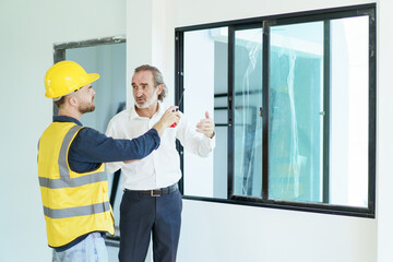 Construction contractor talking with client.