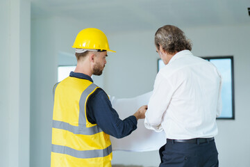 Construction contractor talking with client.