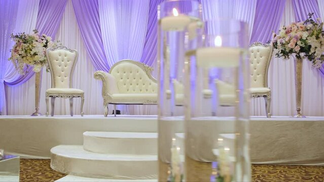 Restaurant filled with tables and chairs and candles on them. Pakistan or Hindi Wedding event 