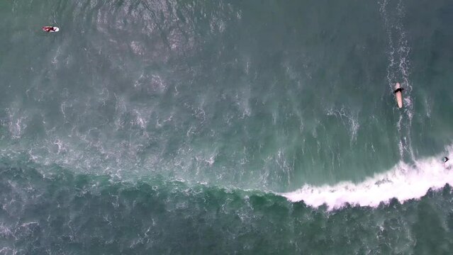 Aerial Top Panning Shot Of People With Surfboards In Wavy Sea During Vacation - Dana Point, California