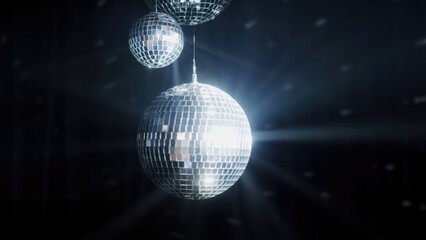 A colorful disco mirror ball illuminates the backdrop of a nightclub. The party lights up the disco ball.