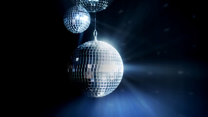 Fototapeta na wymiar A colorful disco mirror ball illuminates the backdrop of a nightclub. The party lights up the disco ball.