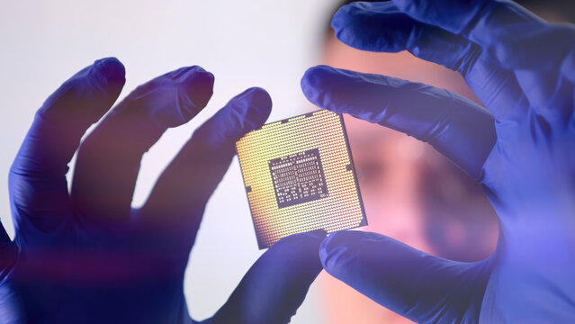 The scientist works in a modern scientific laboratory for the research and development of microelectronics and processors. Microprocessor manufacturing worker uses computer technology and equipment.